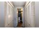 Hallway featuring access to the adjacent bathroom and additional storage closets at 2575 S Syracuse Way # M206, Denver, CO 80231