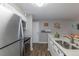 Modern kitchen with stainless steel appliances, gray countertops and wooden floors at 2575 S Syracuse Way # M206, Denver, CO 80231