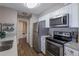Kitchen with stainless steel appliances, modern cabinets, and vinyl wood flooring at 2575 S Syracuse Way # M206, Denver, CO 80231