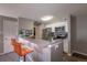 Open kitchen with a modern breakfast bar, stainless steel appliances, and stylish lighting at 2575 S Syracuse Way # M206, Denver, CO 80231