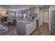 Open-concept floor plan featuring modern kitchen overlooking the living room with fireplace at 2575 S Syracuse Way # M206, Denver, CO 80231