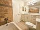 This bathroom boasts tiled walls, shower head, white vanity, and a toilet at 1125 S Oneida St # F, Denver, CO 80224