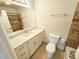 Bathroom featuring tiled floors, a white vanity, a sink, and a toilet at 1125 S Oneida St # F, Denver, CO 80224