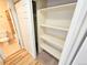 Hallway with a laundry closet and entry to the bathroom and linen closet at 1125 S Oneida St # F, Denver, CO 80224