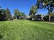 Expansive community lawn with lush green grass, mature trees, and well-maintained landscaping at 1125 S Oneida St # F, Denver, CO 80224