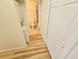 Hallway with a laundry closet and entry to the bathroom at 1125 S Oneida St # F, Denver, CO 80224