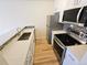 Updated kitchen with stainless steel appliances and quartz countertops at 1125 S Oneida St # F, Denver, CO 80224