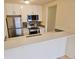 Modern kitchen with white cabinets, stainless appliances, and quartz countertops at 1125 S Oneida St # F, Denver, CO 80224