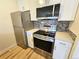 Stylish kitchen features stainless steel appliances and mosaic tile backsplash at 1125 S Oneida St # F, Denver, CO 80224