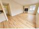 Bright living room with fireplace, hardwood floors, and easy kitchen access at 1125 S Oneida St # F, Denver, CO 80224