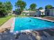 Inviting community pool on a sunny day, complete with lounge chairs, surrounded by mature trees at 1125 S Oneida St # F, Denver, CO 80224