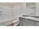 Bathroom with white tiled shower and gray vanity with granite countertop at 1639 Pinnacle Ave, Lochbuie, CO 80603