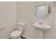 Clean half-bathroom with a pedestal sink, oval mirror, and modern fixtures at 1639 Pinnacle Ave, Lochbuie, CO 80603