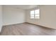 Bright bedroom with plank flooring and a large window overlooking the outdoors at 1639 Pinnacle Ave, Lochbuie, CO 80603