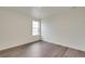 Bright bedroom with light wood-look floors and a window overlooking the outdoors at 1639 Pinnacle Ave, Lochbuie, CO 80603