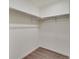 Walk-in closet with painted white walls and wood floor and shelving at 1639 Pinnacle Ave, Lochbuie, CO 80603
