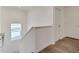 Hallway leading upstairs with natural light from a window and two-panel doors at 1639 Pinnacle Ave, Lochbuie, CO 80603