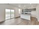 Modern kitchen with stainless appliances, stone countertops, and sliding glass door to the backyard at 1639 Pinnacle Ave, Lochbuie, CO 80603