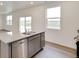 Modern kitchen with granite countertops, stainless steel appliances, and scenic backyard views at 1639 Pinnacle Ave, Lochbuie, CO 80603