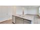 Bright kitchen with gray cabinets, granite countertops, stainless appliances, and an open floor plan at 1639 Pinnacle Ave, Lochbuie, CO 80603