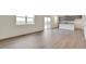 Open living space with a sliding glass door, plank floors, and adjoined modern kitchen at 1639 Pinnacle Ave, Lochbuie, CO 80603
