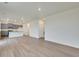 Open-concept living space with modern gray cabinets and plank flooring throughout the home at 1639 Pinnacle Ave, Lochbuie, CO 80603