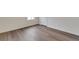 Bright room showcasing wood-look floors, baseboards, and painted walls at 1639 Pinnacle Ave, Lochbuie, CO 80603