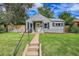 Charming single-story home with gray siding, a well-manicured lawn, and a welcoming front entrance at 4848 Hooker St, Denver, CO 80221