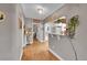 Hallway with hardwood floors, leading to kitchen with stylish decor and convenient access to other rooms at 4848 Hooker St, Denver, CO 80221