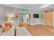 Bright living room featuring hardwood floors, modern decor, and a stylish sliding barn door at 4848 Hooker St, Denver, CO 80221