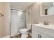 Modern bathroom featuring a glass enclosed shower with marble tiling and a new vanity at 14453 E Jewell Ave # 104, Aurora, CO 80012