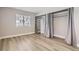 Neutral bedroom with new flooring, a large window and built-in closet space at 14453 E Jewell Ave # 104, Aurora, CO 80012