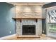 Close up of a living room with a stone fireplace, decorative tile, and balcony access at 14453 E Jewell Ave # 104, Aurora, CO 80012