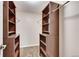 Spacious walk-in closet with built-in shelves and hanging rods at 13500 E Cornell Ave # 309, Aurora, CO 80014