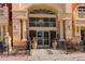 Elegant building entrance with arched entryway, columns, and landscaping at 1950 N Logan St # 102, Denver, CO 80203