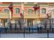 Brick townhome exterior with balconies and wrought iron fence at 1950 N Logan St # 102, Denver, CO 80203