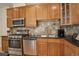 Modern kitchen with wood cabinets and granite countertops at 1950 N Logan St # 102, Denver, CO 80203