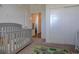 Bright bedroom with a crib and sliding closet doors at 9283 Twenty Mile Rd # 403, Parker, CO 80134