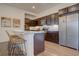 Modern kitchen with dark brown cabinets, granite countertops, and stainless steel appliances at 9283 Twenty Mile Rd # 403, Parker, CO 80134