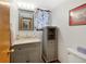 Bathroom with grey vanity, floral curtain, mirror and decorative lighting at 11366 Haswell Dr, Parker, CO 80134