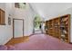 Bright foyer with a soaring ceiling, arched window, and beautiful custom wooden bookcase at 11366 Haswell Dr, Parker, CO 80134