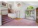 Spacious foyer with high ceiling, arched window, and staircase leading to the upper level at 11366 Haswell Dr, Parker, CO 80134