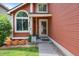 Inviting front door entrance with decorative plants, welcoming sign, and a secure SafeStreets system at 11366 Haswell Dr, Parker, CO 80134
