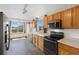 Bright kitchen boasts modern stainless steel appliances and oak cabinets at 11366 Haswell Dr, Parker, CO 80134