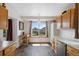 Bright kitchen features oak cabinets, stainless steel appliances, and a large window with a view at 11366 Haswell Dr, Parker, CO 80134