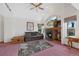 Bright living room offering a fireplace, ceiling fan, comfortable seating, and plush carpeting at 11366 Haswell Dr, Parker, CO 80134