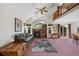 Bright living room featuring fireplace, ceiling fan, comfortable seating, and a door to the backyard at 11366 Haswell Dr, Parker, CO 80134