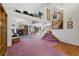 Bright living room with soaring ceiling, fireplace, upper-level landing with plants, and plush carpet at 11366 Haswell Dr, Parker, CO 80134
