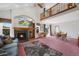 Bright living room boasting a fireplace, door to backyard, a second-story balcony and an adjacent dining area at 11366 Haswell Dr, Parker, CO 80134