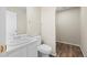 Bright bathroom featuring wood-look flooring, a toilet, and a single sink vanity at 9522 Castle Ridge Cir, Highlands Ranch, CO 80129